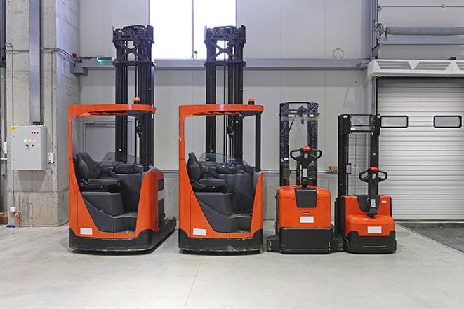 forklifts transporting heavy cargo in manufacturing facility